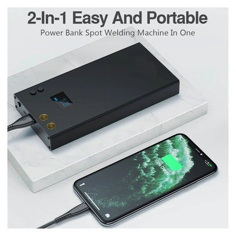 Handheld Portable Spot Welder Pen For 18650 Battery Packs And Nickel Soldering DIY Welding Tool with LCD display next to phone charging