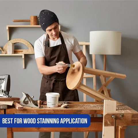 No Hassle One Inch Disposable Chip Brushes With Natural Bristles For Smooth As Butter Paint And Stain Touch Ups In A Twelve Pack Straight To Your Tool Shed Today, man staining wood furniture with brush in workshop.
