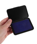 Dead Zero Smudge Fast Dry Pigment Ink Pad for Rubber Stamps, purple pad held in hand, quick setting for crafting and signatures.