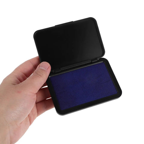 Dead Zero Smudge Fast Dry Pigment Ink Pad for Rubber Stamps, purple pad held in hand, quick setting for crafting and signatures.