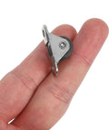 Eight Piece Low Profile Rigid Rubber Caster Wheels Non Swivel Fixed Plate Casters With Silent Rolling And Floor Saving Design For Heavy Furniture Bedroom Appliances And Small Trolleys No Sweat Moving For Your Furniture Everyday. A fixed caster wheel in hand, showcasing its compact size and sturdy metal plate for easy mounting.