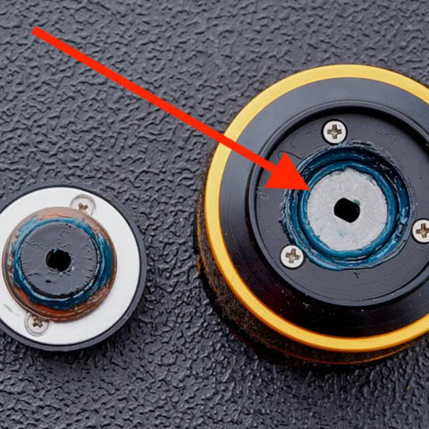 Close-up of fishing reel gears with Black Fishing Reel Grease 2 Oz For Smooth Casting And Maintenance applied to moving parts.