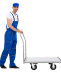 Heavy Duty Platform Truck Cart With Rock Solid Steel Deck And Smooth Roll Casters Built To Shift Two Thousand Pounds Like A Pro Warehouse Workhorse For Daily Hauling Tasks, showcased with a man in blue overalls.