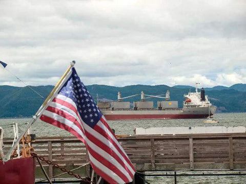 Ditch The Tangle Knot To The Curb With This Slick 360 Rotating Flag Pole Mounting Ring Clip Built For No Sweat Assembly And Bright Yard Showcase All Season Long with American flag in foreground and cargo ship in background.