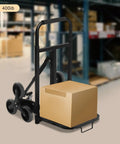 Beefy 400lbs Foldable Hand Truck Dolly, Steel Heavy Duty Folding Cart for Moving Furniture and Boxes, Three Wheel Design For Flat Ground Or Stairs, Spray Coated Black Finish, Durable, Portable Cargo Helper with box on warehouse floor