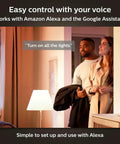 Couple using voice control with Alexa to adjust lighting, showcasing Smart 60W ST19 Filament LED Bulb 2 Pack Soft Warm White 550LM E26 Indoor Lighting With Hue App Control Compatible With Alexa Google Assistant And Apple HomeKit.