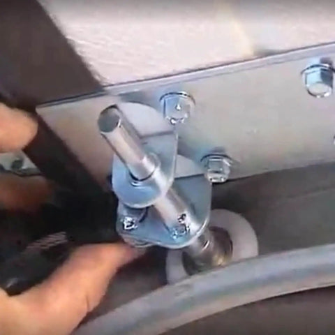 Installation of Two Pack 1.8 Inch White Nylon Garage Door Roller With Silent Ball Bearings on wooden gate system.