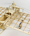 Top view of DIY Balsa Wood Airplane Kit For Adults Dope Laser Cut Bleriot Style Model Plane with lattice detailing and wires.