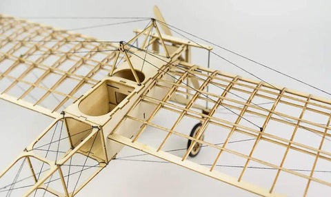 Top view of DIY Balsa Wood Airplane Kit For Adults Dope Laser Cut Bleriot Style Model Plane with lattice detailing and wires.