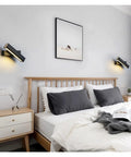 Elevate Your Home Vibe With This Sleek Black Metal Swivel Wall Sconce Led Lighting For Bedroom Living Room And Hallways Rustproof Adjustable Accent Lamp beside a bed.