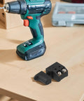 Heavy Duty Variable Speed Trigger Switch With Dead Easy Turn Knob For Electric Drill And Circular Saw Lock On Or Self Rest Mode Black Housing next to a cordless drill on a wooden surface.