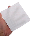 Hand holding sheet of Clear Silicone Furniture Pads 200 Pack No Slip Bumpers For Chair Legs Table Feet Cabinets Doors Floor Protection and Noise Dampening