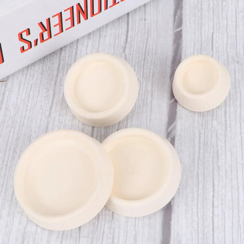 White Rubber Sink Stopper with Hanging Ring 4pcs for Bathtub Drains displayed on a wooden surface, showcasing four round stoppers.