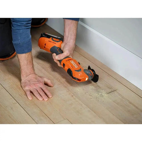 Person using 18V Cordless Oscillating Multi Tool Kit With Two 2.0Ah Batteries And Charger Quick Change Accessory System on wood floor