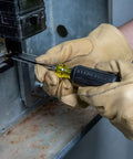 Person using a screwdriver from the Six Piece Screwdriver Set With Cushion Grip Comfort, Precision Machined Flathead And Phillips Bits, Includes Three Sixteenth Inch Cabinet Tip, One Quarter Inch And Five Sixteenth Inch Keystone Tips, Made In USA on an electrical panel