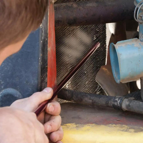 Person using Pro Grade High Pressure 24 Air Comb Filter And Radiator Cleaner with 90 Degree Reach on machinery filter.