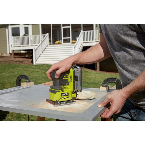 18V Palm Sander Pro Grade With 12,000 RPM 1/4 Sheet Power, Onboard Dust Bag, ergonomic grip in use on outdoor wood project