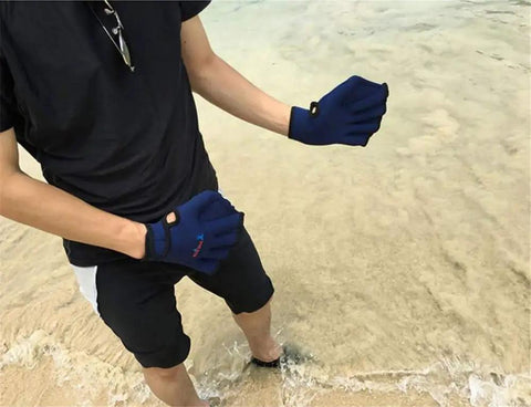 Person wearing Webbed Swim Gloves For Water Training Neoprene Paddling Gloves With Adjustable Velcro Wrist Resistance Boost in sand