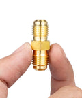 1/4 Inch Male Flare To 1/4 Inch Male Flare Brass Gas Adapter Union Coupler Pipe Fitting held between fingers