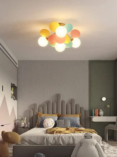 Colorful Globe 4 Light Modern Chandelier With Milk White Glass Shades Fun Globe Semi Flush Mount Lighting in a kids room.