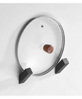 Heavy Duty Wall Hooks Hella Durable Stainless Steel Coat Hanger Double Robe Rack Rustproof Smooth Finish Zero Hassle Home Organization Nail Screw Mount For Bathrooms Closets Light Grey on wall with a transparent lid and brown knob.