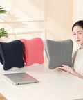 Woman holding gray Comfort Enhancing Desk Headrest Pillow For Office Use Ergonomic Memory Foam Chair Neck Support Breathable Head Cushion for desk naps next to black and pink versions on a desk.