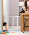 Heavy Duty Pet Safety Gate With Auto Close, extra tall and wide design, installed between kitchen and hallway, toddler playing nearby.