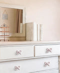 Snag These Premium Vintage Pink Bow Cabinet Knobs 6 Pack Farmhouse Traditional Solid Metal Drawer Pulls on white dresser.
