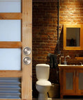 Satin Nickel Closet Door Finger Pull installed on sliding barn door in rustic bathroom