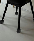 Non Slip Rubber Chair Leg Caps on black chair legs, 4-piece set, protecting hardwood floors.