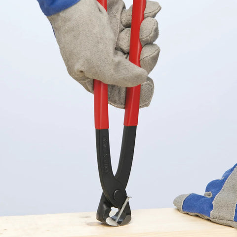 Worker using Concreters Nippers With Plastic Coating, 8 3/4 Inch Pliers For Concrete Work, cutting wire on construction site.