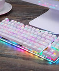 Wired Mechanical Gaming Keyboard With Slick Clicky Feel And Vivid RGB Backlight Built For PC Players Demanding Lightning Fast Typing Through Nine Flashing Light Designs To Straight Up Upgrade Your Entire Desk Setup on a wooden desk.