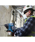 Worker using Lightweight 18V Brushless SDS Plus Bulldog Rotary Hammer Bare Tool With Three Quarter Inch Chuck on concrete wall