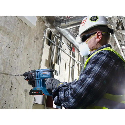 Worker using Lightweight 18V Brushless SDS Plus Bulldog Rotary Hammer Bare Tool With Three Quarter Inch Chuck on concrete wall