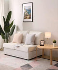 Living room scene with Gold Modern Hollow Out Base Table Lamp With White Fabric Shade on side table beside white sofa.