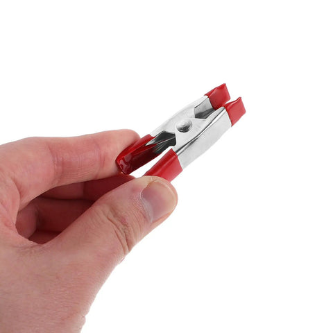 Super Sturdy 12 Piece Heavy Duty Metal Spring Clamps With Red Coated Jaws, Perfect For Woodworking Crafts Panel Fixing And DIY Household Projects That Rock. metal spring clamp held in hand