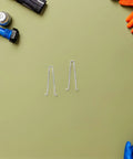 Upgrade Your Manicure Game With This 10Pcs Stainless Steel Torsion Spring Set For Toenail Clippers And Nail Nippers, Fast Install And Compact Salon Quality Gear To Fix Grooming Tools Like A Boss. Two stainless steel torsion springs on a green background