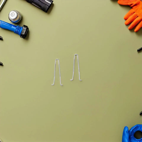 Upgrade Your Manicure Game With This 10Pcs Stainless Steel Torsion Spring Set For Toenail Clippers And Nail Nippers, Fast Install And Compact Salon Quality Gear To Fix Grooming Tools Like A Boss. Two stainless steel torsion springs on a green background