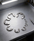 120 Piece External Retaining Rings Kit For Mechanical Projects, Durable Stainless Steel Snap Rings In A Variety Of Sizes From M5 To M10, Built For Tough Jobs, Quick Installations, And Snug, Reliable Fits. stainless external retaining rings laid out with installation tool