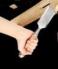 Pro Level Wood Chisel Set With Sturdy Wooden Handles And Razor Sharp Steel Blades held in hand for precise detailing on wood.