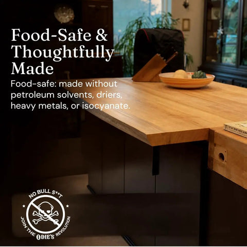 Real Deal Universal Surface Finish For Wood Leather Plastic Vinyl And Metal That Is Straight Up Waterproof And Food Safe While Acting As A Hella Solid Solvent Free Non Toxic Protection Layer Inside A Handy Four Ounce Jar For Instant Glow Ups on a food-safe wooden countertop.
