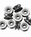 Ten pack of Double Sealed Carbon Steel V Groove Bearing And Pulley Wheel 4X13X6MM on a flat surface for linear motion systems.