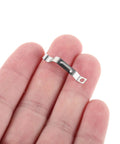 Rock Solid Metal Push Button Spring Clip For Zero Hassle Umbrella Repair And Patio Sun Shade Replacement Quick Swap Switch Assembly held in hand.