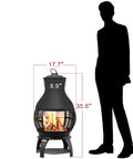 Compact Wood Burning Chiminea Fire Pit For Outdoors, Small Patio Outdoor Fireplace, 17.7 Inches Wide, 35.6 Inches Tall beside silhouette.