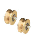 Bad Ass Four Inch Solid Steel Groove Power Wheels With Smooth Ball Bearings Gold Zinc Plated V Track Rollers pair viewed from the side.