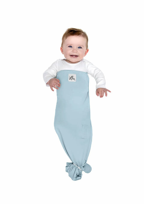 Baby wearing adjustable baby swaddle for newborns that feels like the womb pediatrician recommended safe sleep solution