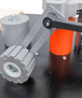 Close-up of the roller mechanism on Full Auto Edge Banding Machine Woodworking Benchtop Station with precision parts.