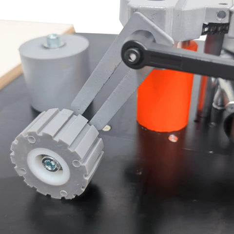 Close-up of the roller mechanism on Full Auto Edge Banding Machine Woodworking Benchtop Station with precision parts.