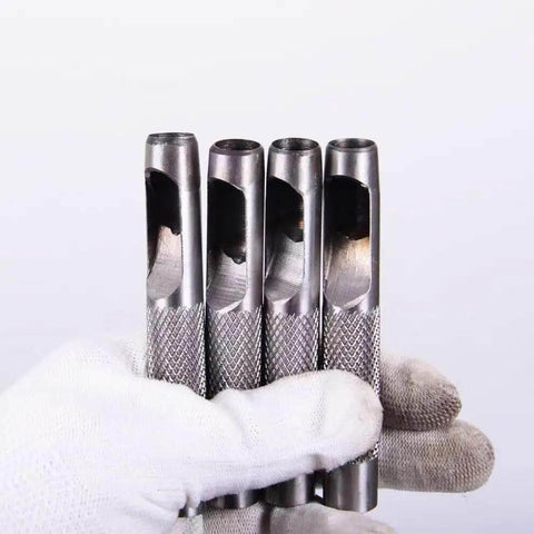 Pro Grade Leather Punch Set With Steel Hollow Punches held in a gloved hand, showcasing durable steel build and texture.