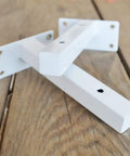 Legit White Shelf Brackets And T Shape Wall Mounts Solid Iron Floating Shelf Hardware Straight Up Easy Install on wooden surface.